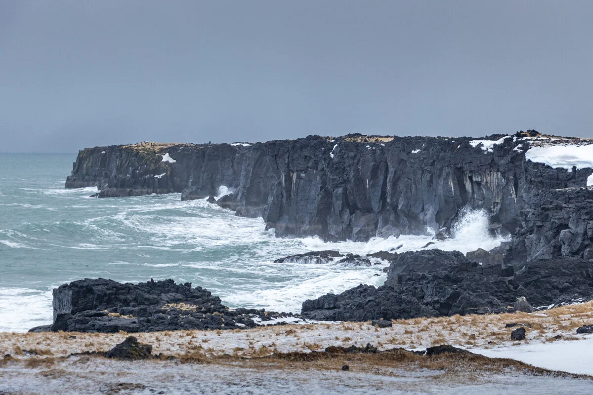 falaises basaltiques noires surplombant l'océan avec vagues