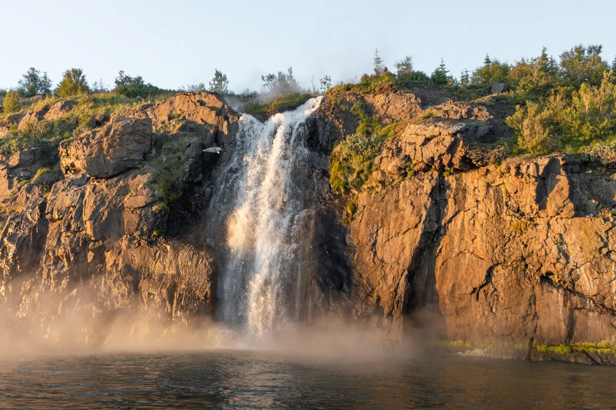 une cascade se jette d'une falaise rocheuse