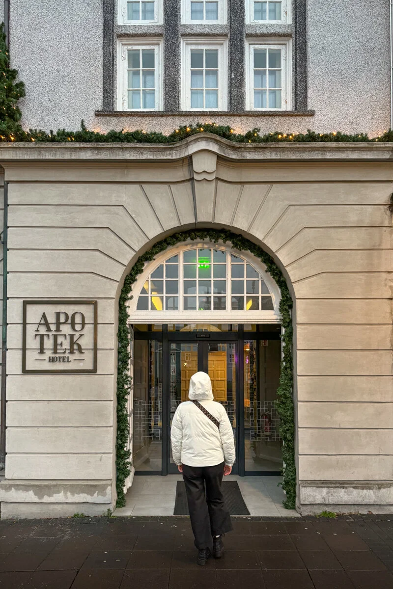 une personne de dos qui entre dans l'hôtel Apotek